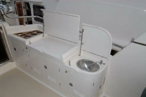  Yacht Photos Pics Outdoor kitchen area on a 2026 Selene 54 yacht with sink and storage.