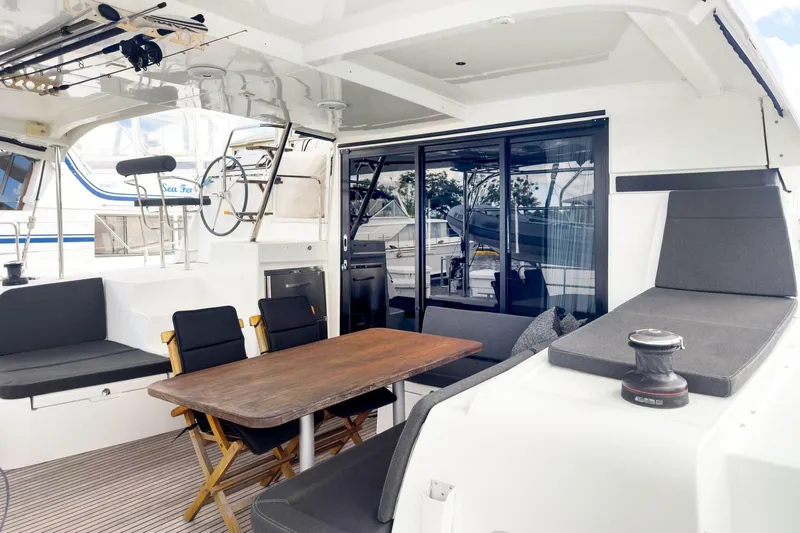 Sweet Sweet Life Yacht Photos Pics Spacious 2020 Lagoon 42 yacht interior with seating, table, and helm station.