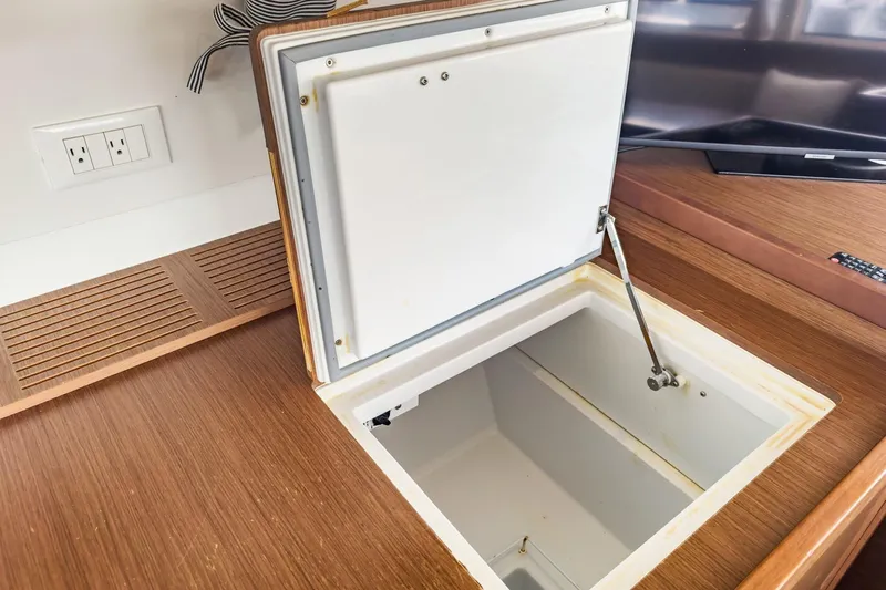 Sweet Sweet Life Yacht Photos Pics Open storage compartment on Lagoon 42 catamaran, 2020 model, with wooden finish.