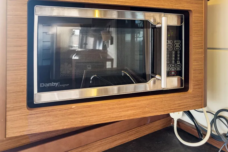 Sweet Sweet Life Yacht Photos Pics Built-in Danby Designer microwave in Lagoon 42, 2020 model, wooden cabinetry.