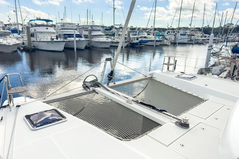 Sweet Sweet Life Yacht Photos Pics 2020 Lagoon 42 catamaran docked in a marina with other boats.