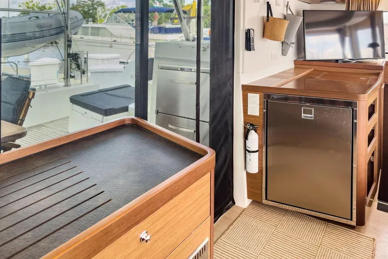 Sweet Sweet Life Yacht Photos Pics Interior of a 2020 Lagoon 42 yacht featuring a modern kitchen and outdoor view.