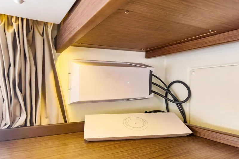 Sweet Sweet Life Yacht Photos Pics Modern interior of 2020 Lagoon 42 yacht with sleek electronic device and wooden accents.