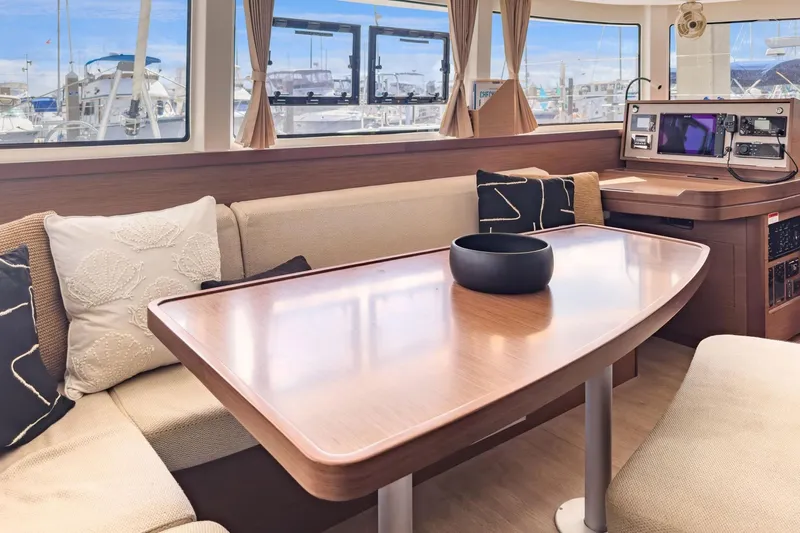 Sweet Sweet Life Yacht Photos Pics Interior of 2020 Lagoon 42 catamaran with elegant seating and navigation station.