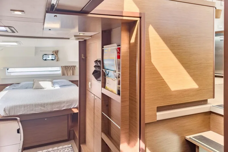 Sweet Sweet Life Yacht Photos Pics Interior of 2020 Lagoon 42 yacht featuring a cozy bedroom and modern wooden finishes.