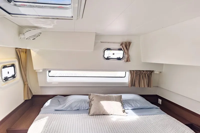 Sweet Sweet Life Yacht Photos Pics Luxurious cabin interior of 2020 Lagoon 42 catamaran with cozy bedding and natural light.