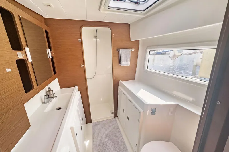 Sweet Sweet Life Yacht Photos Pics Modern bathroom interior of 2020 Lagoon 42 yacht with shower and window view.