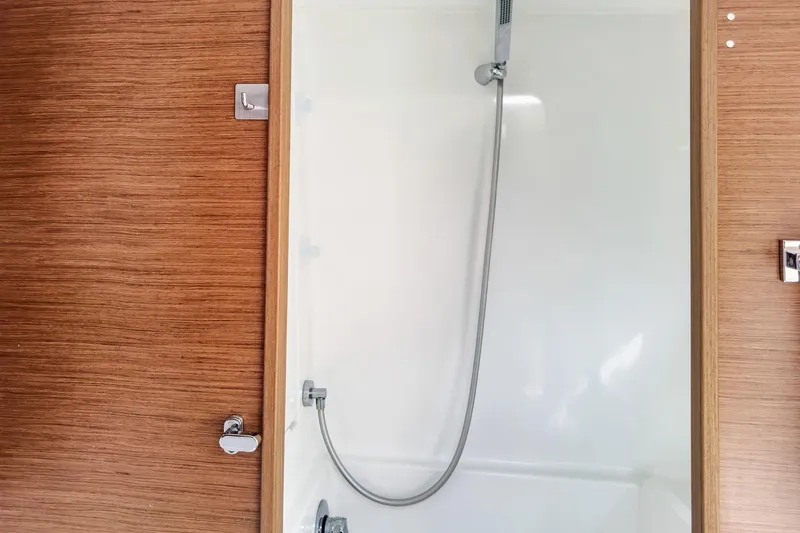 Sweet Sweet Life Yacht Photos Pics Shower area in 2020 Lagoon 42 yacht with wooden paneling and modern fixtures.