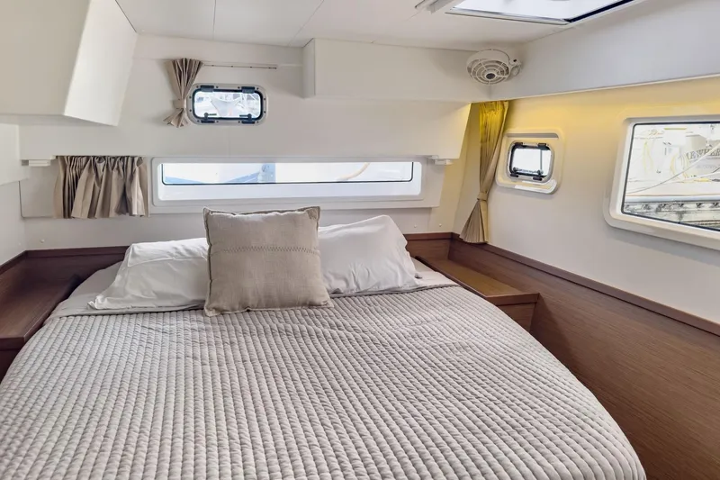Sweet Sweet Life Yacht Photos Pics Cozy cabin interior of 2020 Lagoon 42 catamaran with comfortable bedding and natural light.