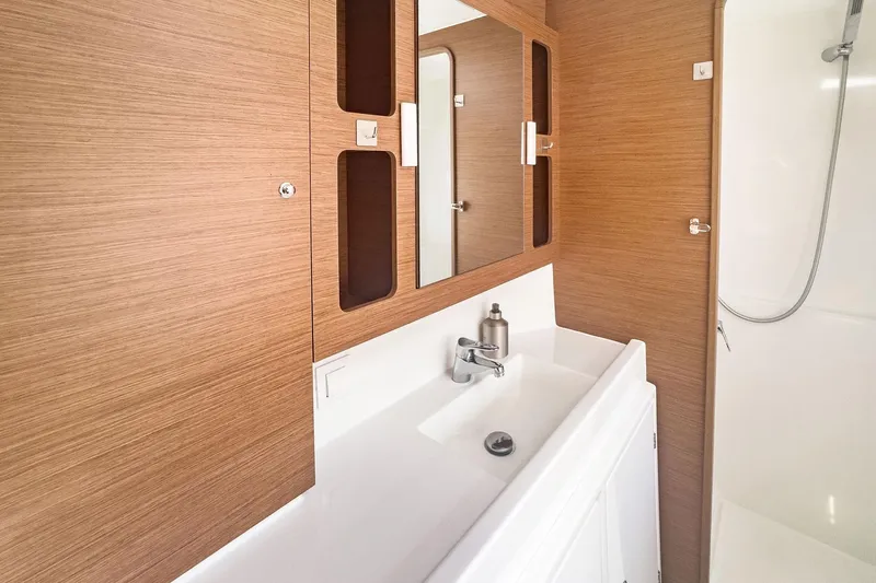 Sweet Sweet Life Yacht Photos Pics Modern bathroom interior of 2020 Lagoon 42 yacht with wooden accents and sleek fixtures.