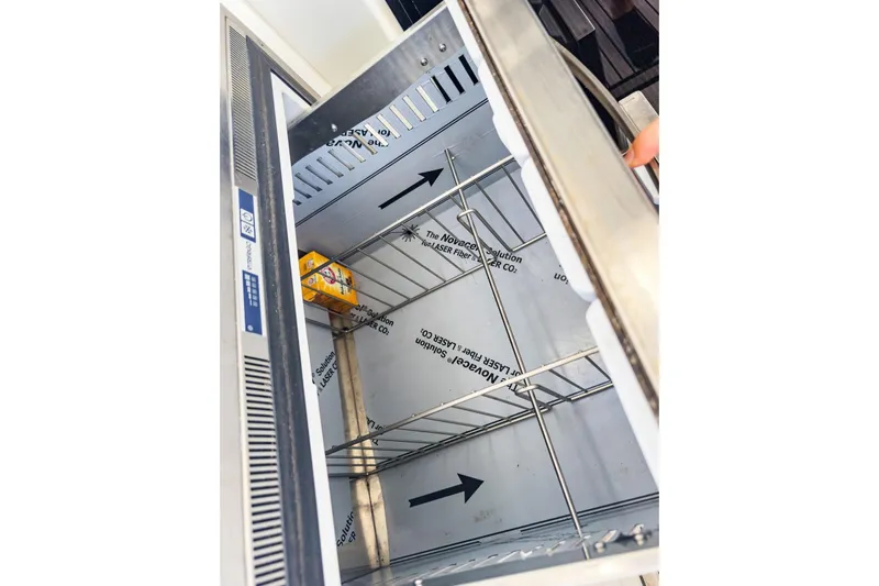 Sweet Sweet Life Yacht Photos Pics Open refrigerator on Lagoon 42 yacht, 2020 model, with a single item inside.