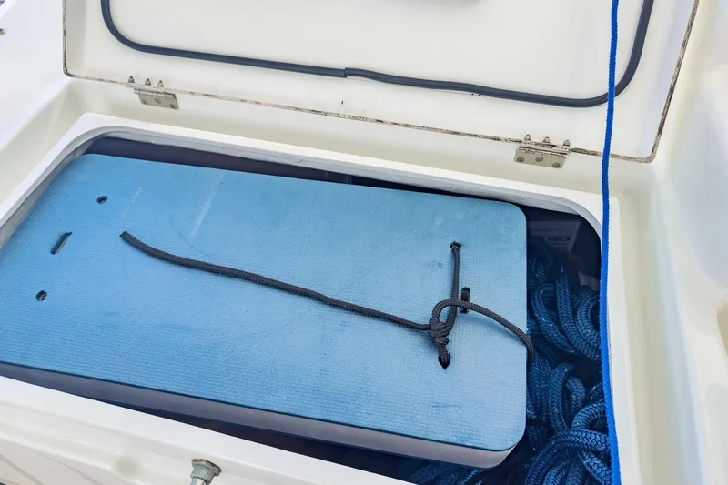 Sweet Sweet Life Yacht Photos Pics Open storage compartment on Lagoon 42 yacht, featuring blue ropes and a secured mat.