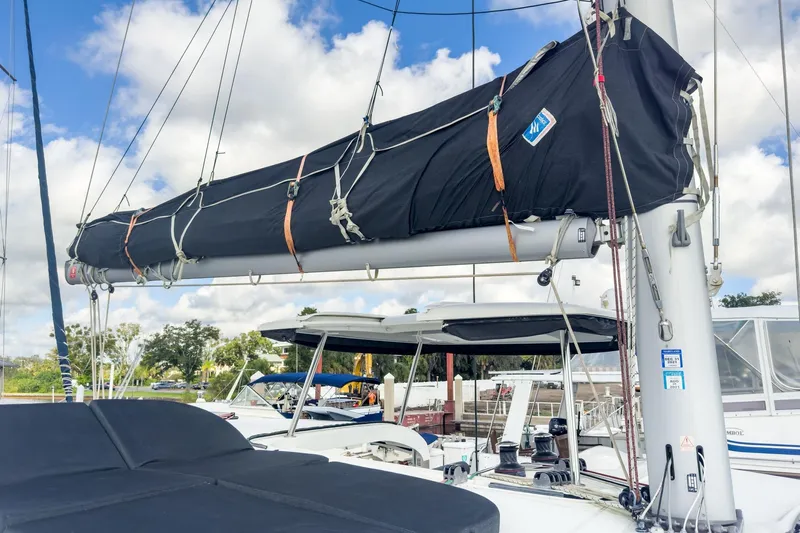 Sweet Sweet Life Yacht Photos Pics 2020 Lagoon 42 sailboat with covered boom, docked under a partly cloudy sky.