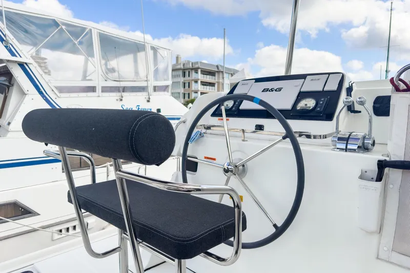 Sweet Sweet Life Yacht Photos Pics Helm of 2020 Lagoon 42 catamaran with steering wheel and navigation controls.