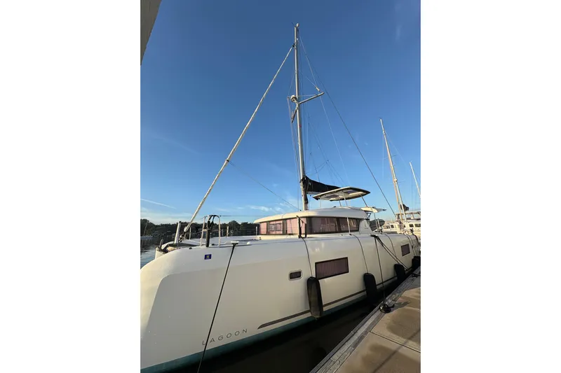 Sweet Sweet Life Yacht Photos Pics 2020 Lagoon 42 catamaran docked under clear blue sky.