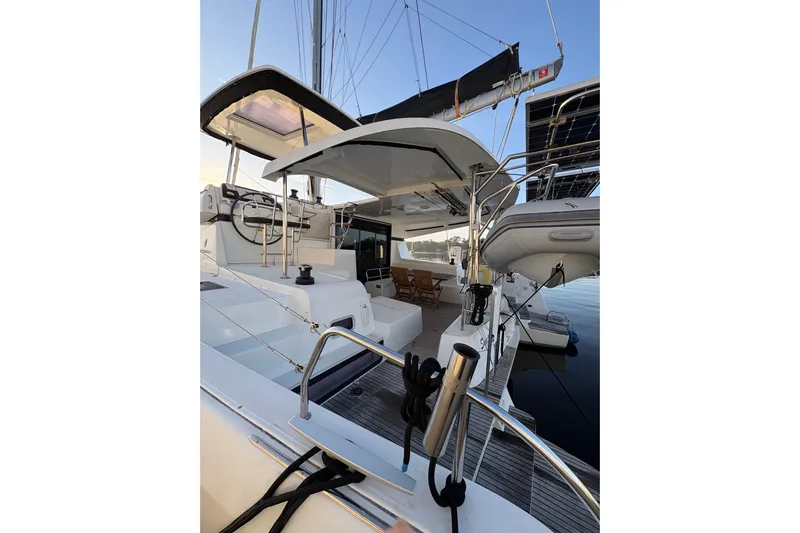 Sweet Sweet Life Yacht Photos Pics 2020 Lagoon 42 catamaran with modern deck and seating area, docked at marina.
