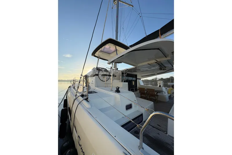 Sweet Sweet Life Yacht Photos Pics 2020 Lagoon 42 catamaran docked at sunrise, showcasing sleek design and spacious deck.
