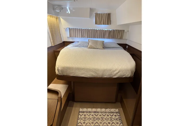 Sweet Sweet Life Yacht Photos Pics Cozy bedroom interior of 2020 Lagoon 42 yacht with elegant wood finish.