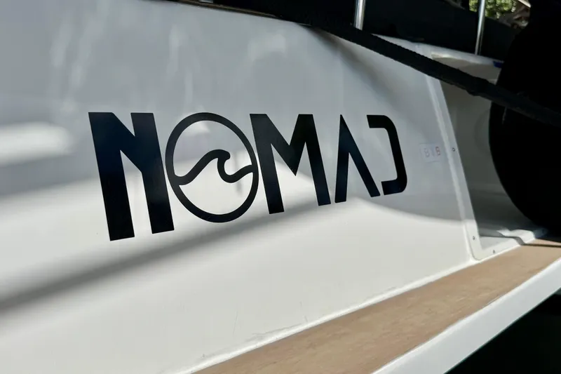 Owners Version Yacht Photos Pics "Nomad" logo on 2020 Lagoon 42 catamaran, featuring sleek design and modern aesthetics.