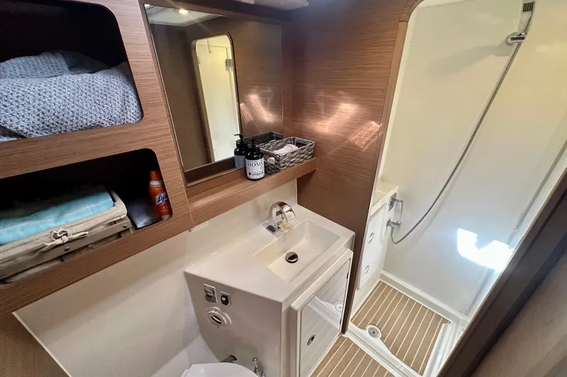 Owners Version Yacht Photos Pics Modern bathroom in 2020 Lagoon 42 yacht with shower and wooden accents.