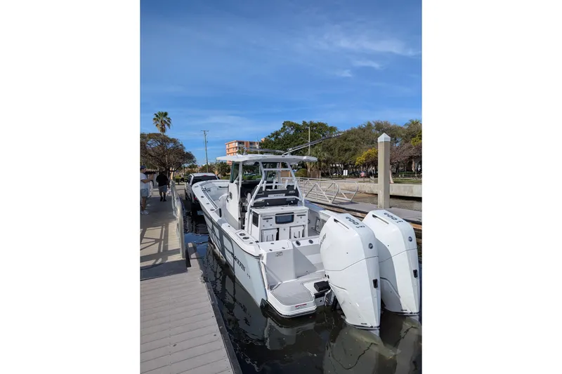  Yacht Photos Pics 2024 Blackfin 332 CC boat docked, featuring dual outboard engines and sleek design.