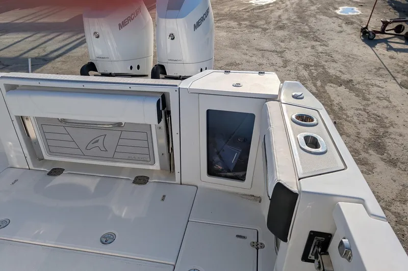  Yacht Photos Pics 2024 Blackfin 332 CC boat deck with Mercury engines and storage compartments.