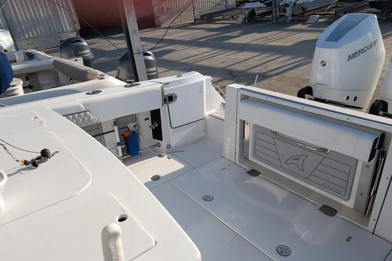  Yacht Photos Pics 2024 Blackfin 332 CC boat interior with Mercury outboard engine, showcasing spacious deck layout.
