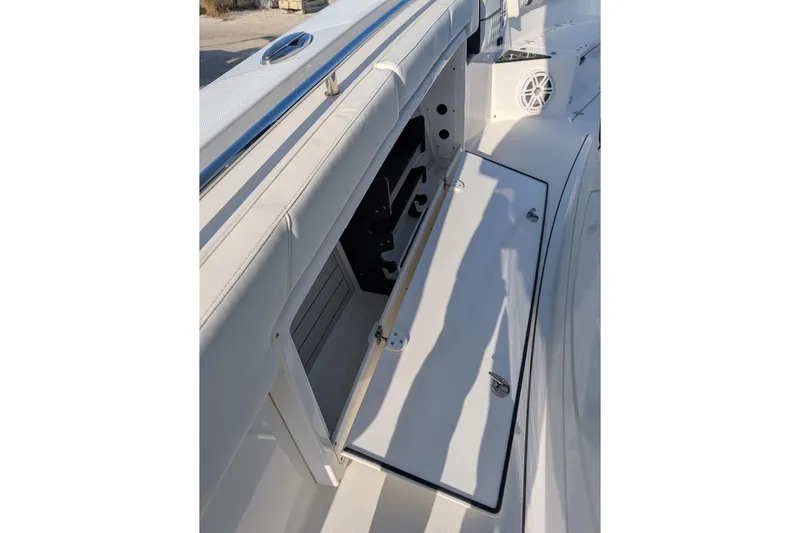  Yacht Photos Pics 2024 Blackfin 332 CC boat storage compartment with open hatch and speaker.