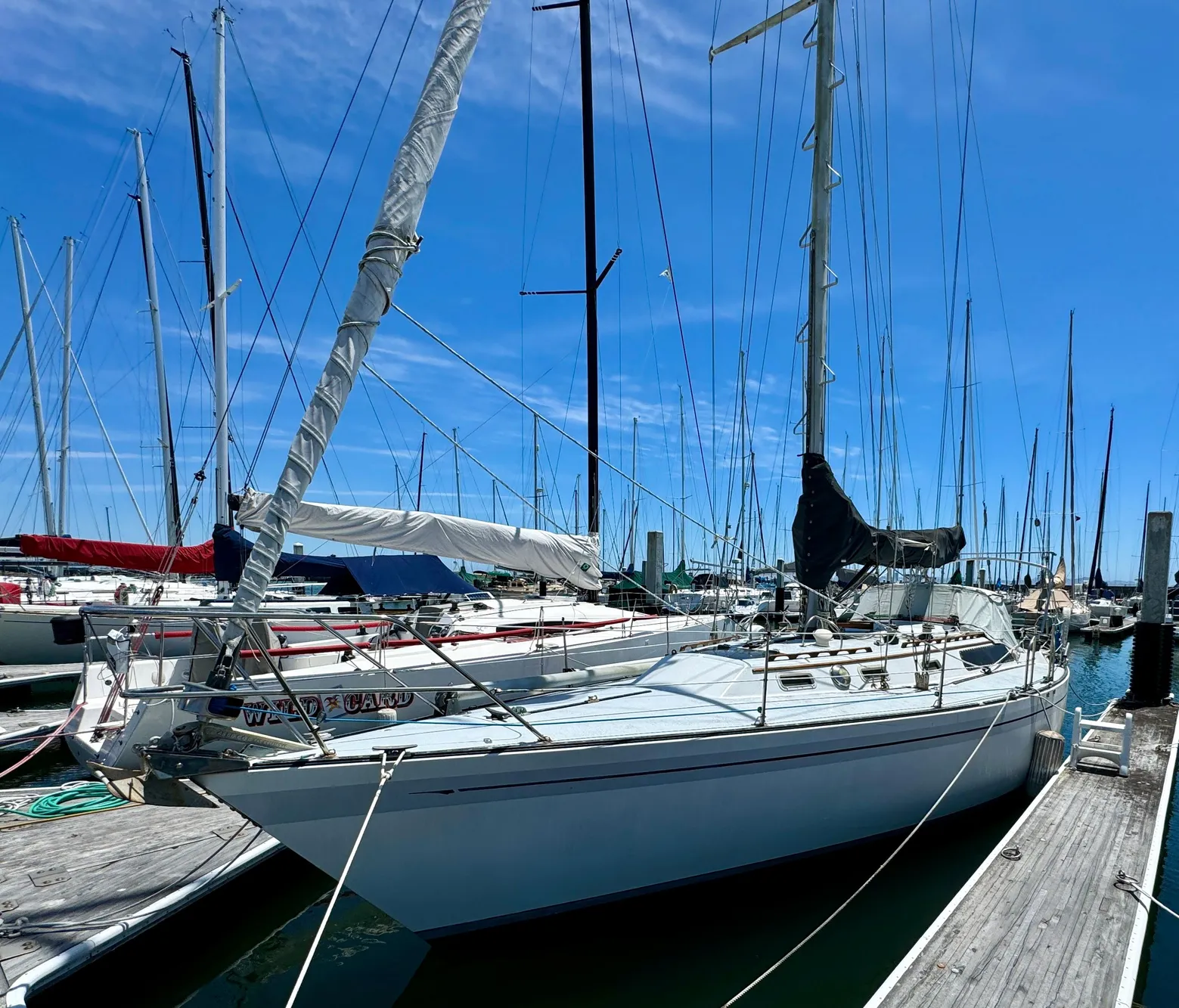 1979 Islander IP Peterson 40 sailboat docked at marina under clear blue sky.