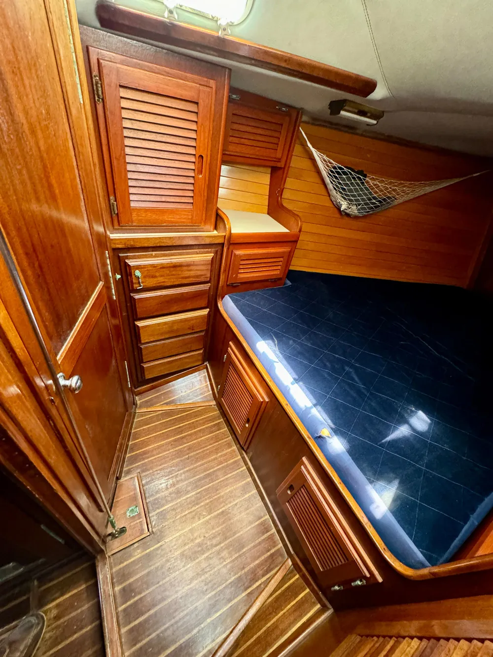 1979 Islander IP Peterson 40 cabin with wooden interior and blue bedding.