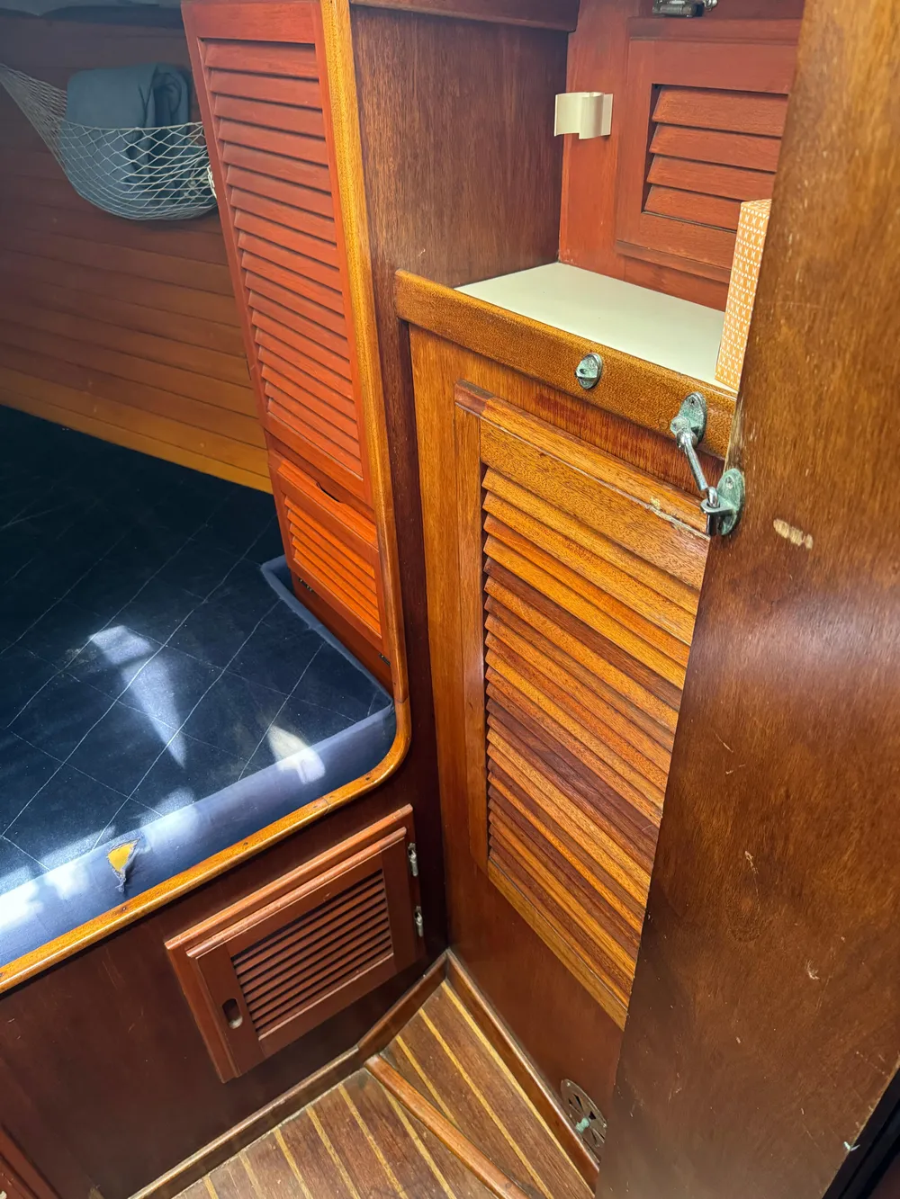 1979 Islander IP Peterson 40 interior with wooden cabinetry and cushioned seating.