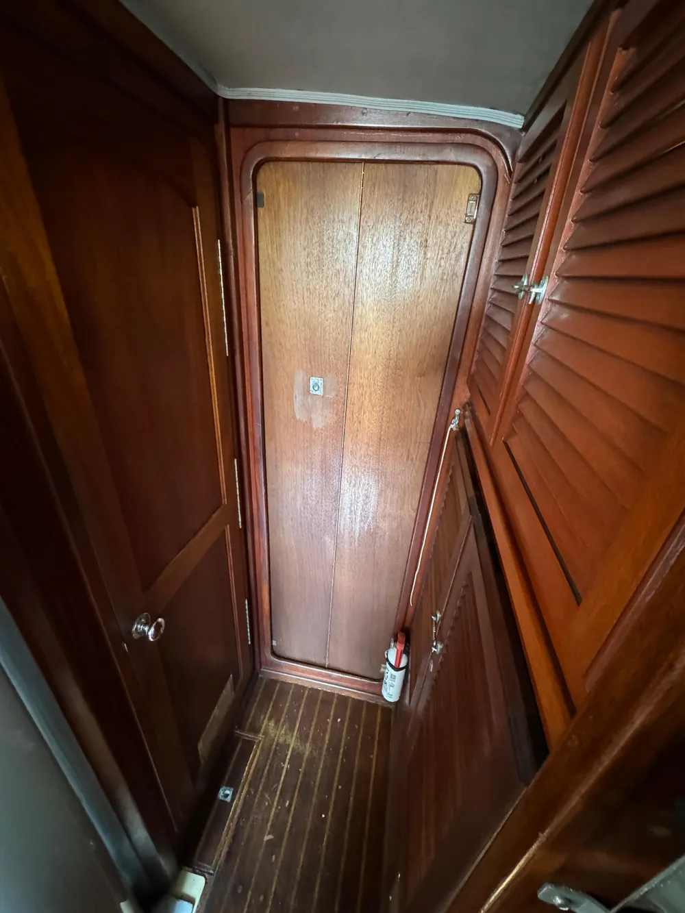 1979 Islander IP Peterson 40 interior with wooden doors and flooring.