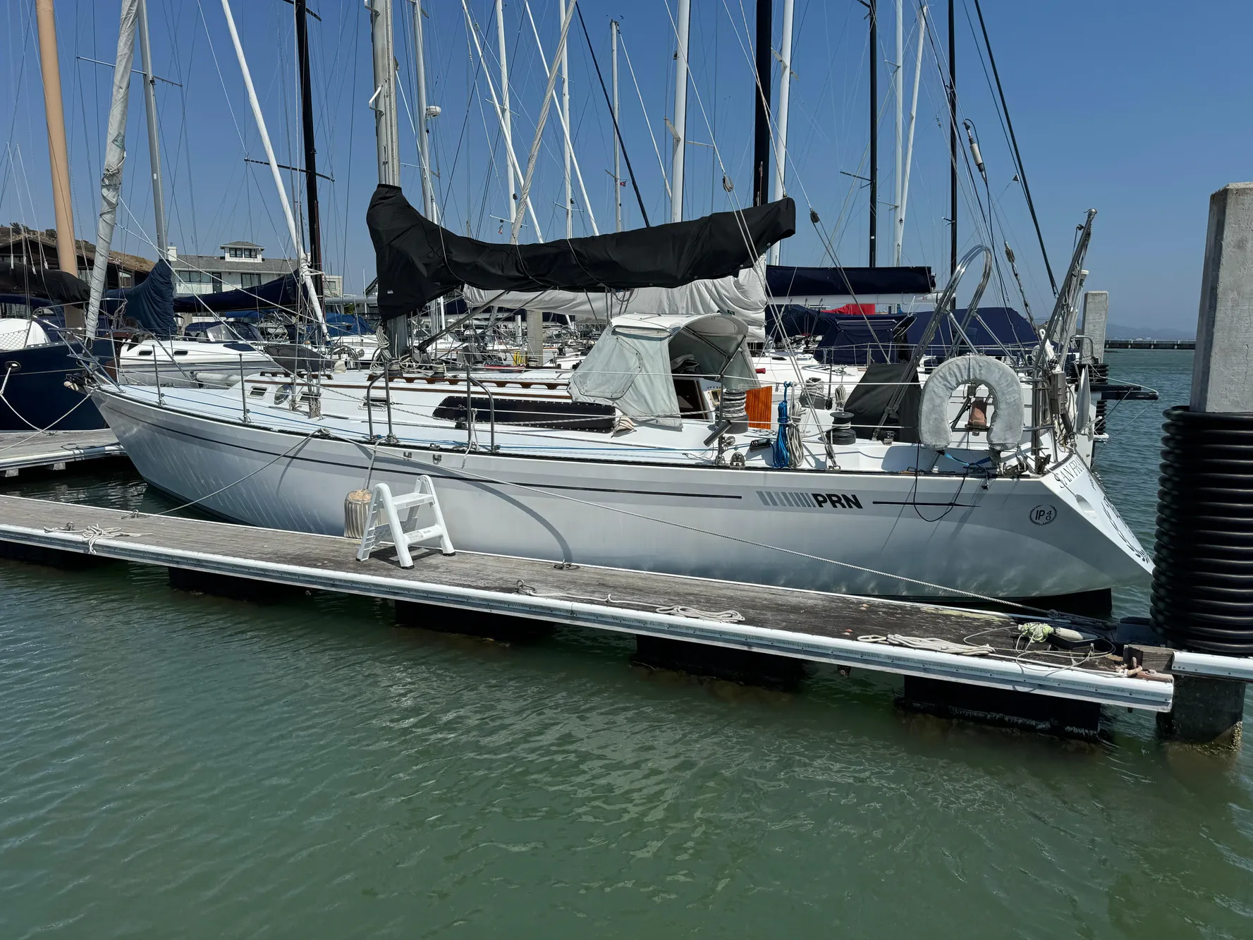 1979 Islander IP Peterson 40 sailboat docked at marina, surrounded by other vessels.