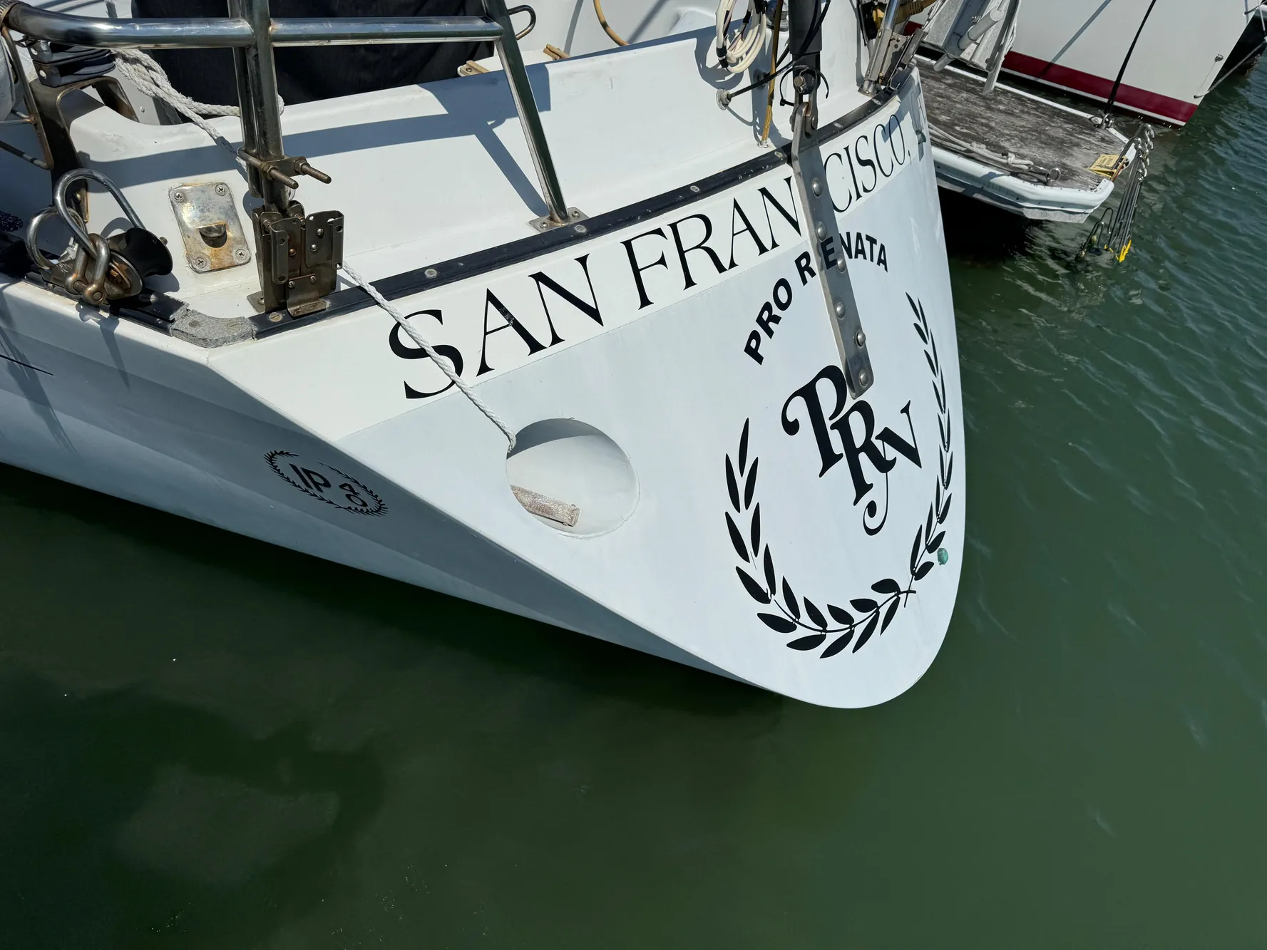 Bow of 1979 Islander IP Peterson 40 sailboat docked in San Francisco marina.