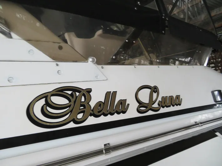 Bella Luna Yacht Photos Pics Ocean Alexander 48 Cockpit Motoryacht 1990, named "Bella Luna," docked in a marina.