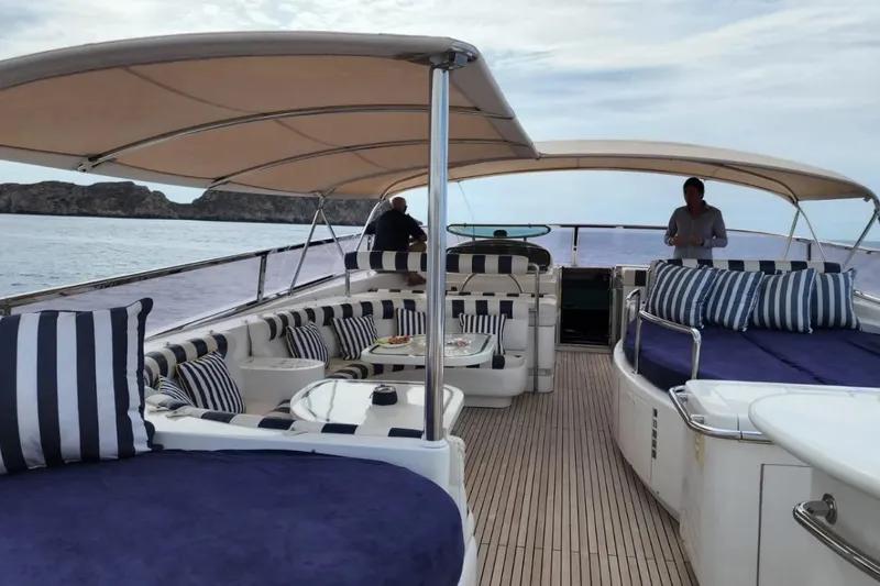  Yacht Photos Pics Luxurious 2002 Horizon 105 yacht deck with striped cushions and scenic ocean view.