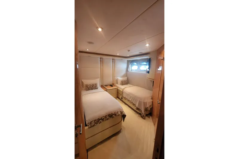  Yacht Photos Pics Luxurious twin bedroom in 2002 Horizon 105 yacht with elegant decor and soft lighting.