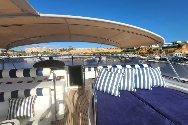  Yacht Photos Pics Luxurious 2002 Horizon 105 yacht deck with striped cushions and scenic marina view.