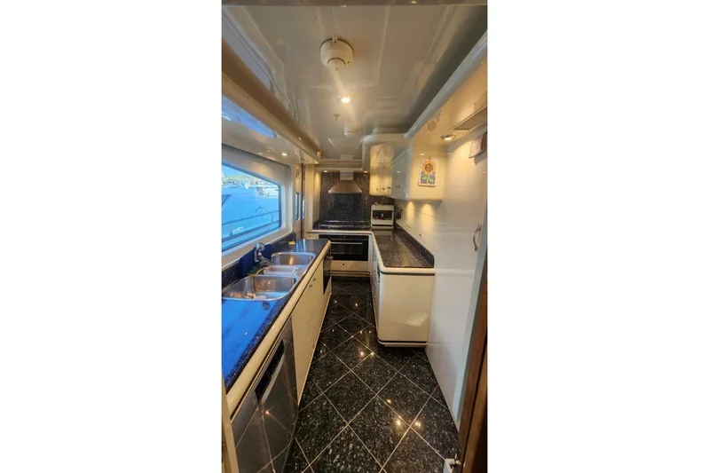  Yacht Photos Pics Luxurious kitchen interior on 2002 Horizon 105 yacht with modern appliances and sleek design.