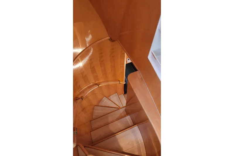  Yacht Photos Pics Polished wooden spiral staircase on 2002 Horizon 105 yacht interior.