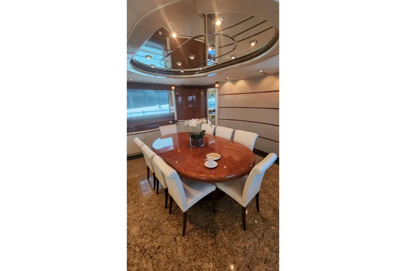  Yacht Photos Pics Luxurious dining area on 2002 Horizon 105 yacht with elegant table and chairs.