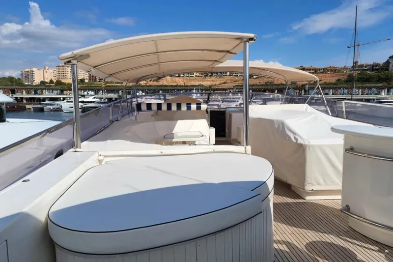  Yacht Photos Pics Luxurious 2002 Horizon 105 yacht deck with seating and canopy in marina.