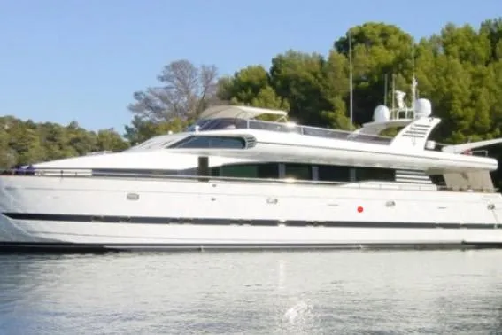  Yacht Photos Pics Luxury Horizon 105 yacht from 2002 docked near lush green trees.