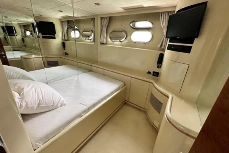  Yacht Photos Pics Luxurious bedroom interior of 2002 Horizon 105 yacht with mirrored walls and modern amenities.