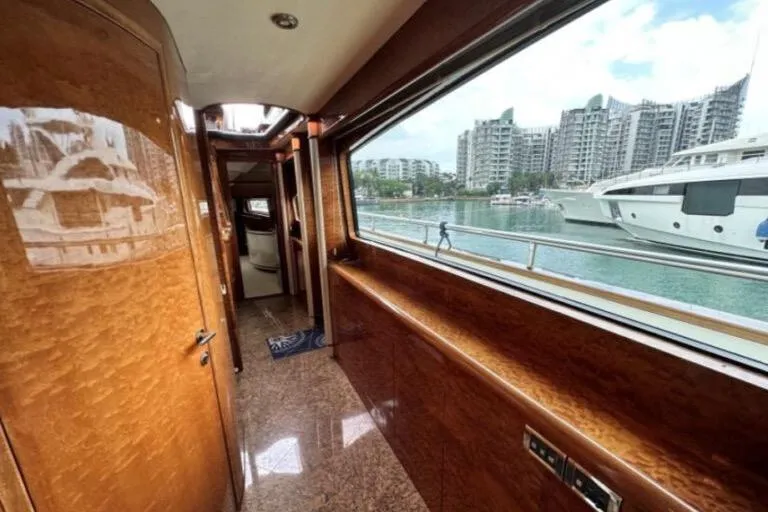  Yacht Photos Pics Luxurious Horizon 105 yacht interior with wood paneling, large window, and marina view, 2002 model.