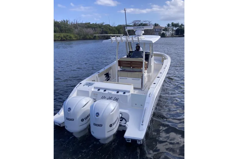 No Jet Lag Yacht Photos Pics 2019 Pursuit S 288 Sport boat with twin Yamaha engines on a calm waterway.