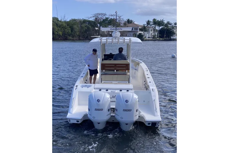 No Jet Lag Yacht Photos Pics 2019 Pursuit S 288 Sport boat on water with two people onboard.