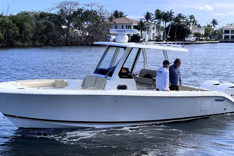 No Jet Lag Yacht Photos Pics 2019 Pursuit S 288 Sport boat cruising on a scenic waterway with two people onboard.