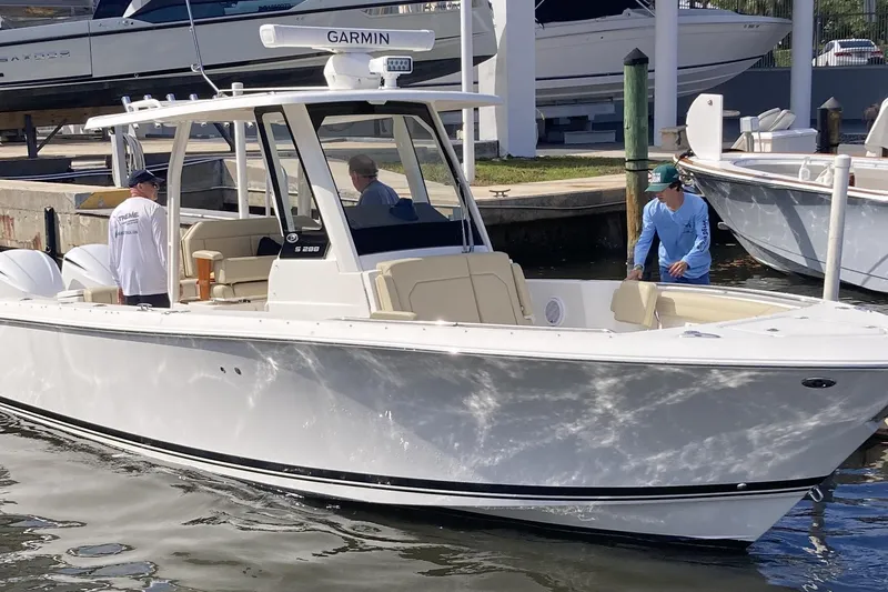 No Jet Lag Yacht Photos Pics 2019 Pursuit S 288 Sport boat docked with people onboard, featuring Garmin equipment.