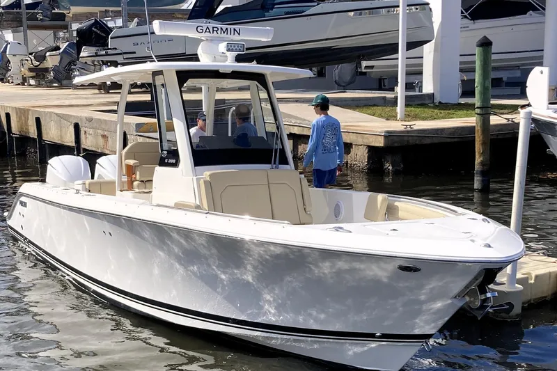 No Jet Lag Yacht Photos Pics 2019 Pursuit S 288 Sport boat docked at marina with people onboard.